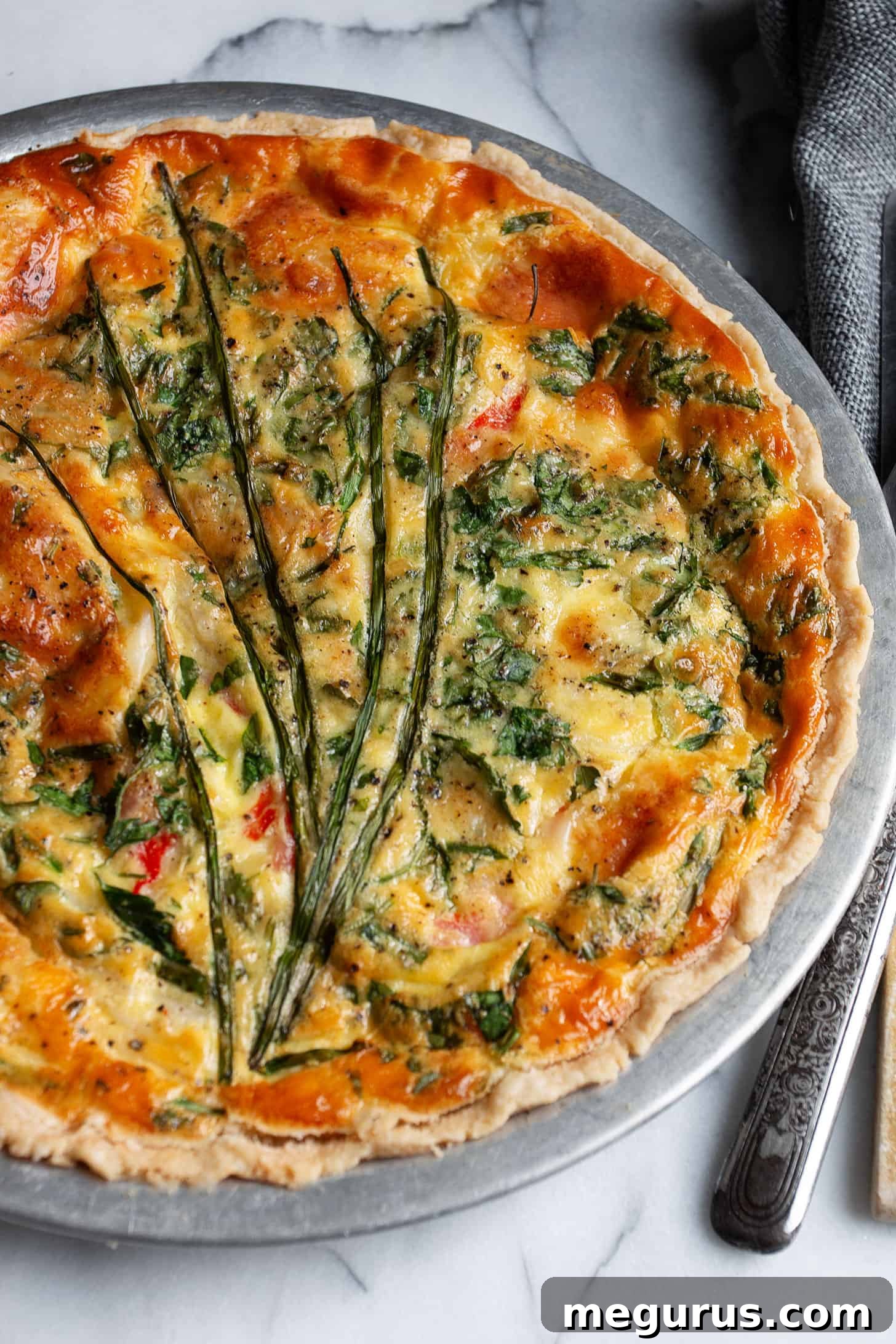 Close-up of a golden-brown crab quiche, freshly baked and ready to serve