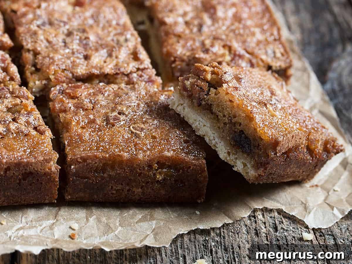 Golden Maple Bacon Squares cut on parchment paper, showcasing their rich texture and delectable filling.
