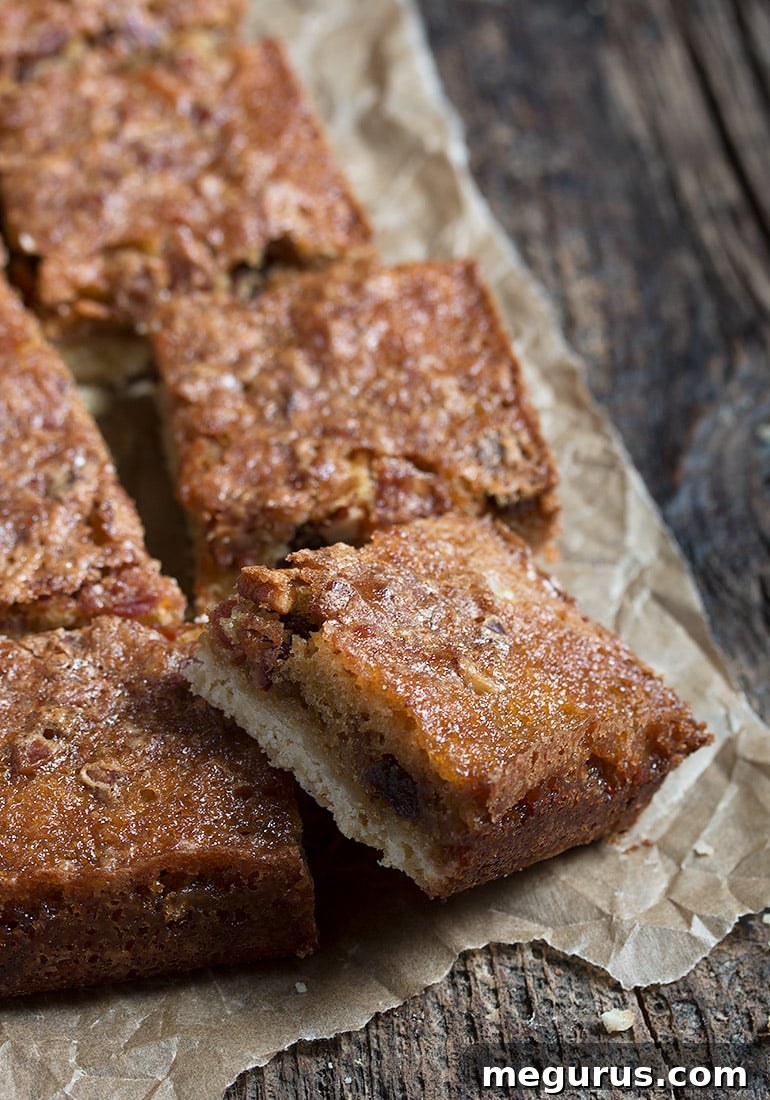 Maple Bacon Bars sliced and arranged beautifully on a white surface, highlighting the layers of crust and filling.