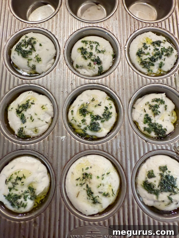 Herb oil spooned on top of the focaccia muffins before baking.