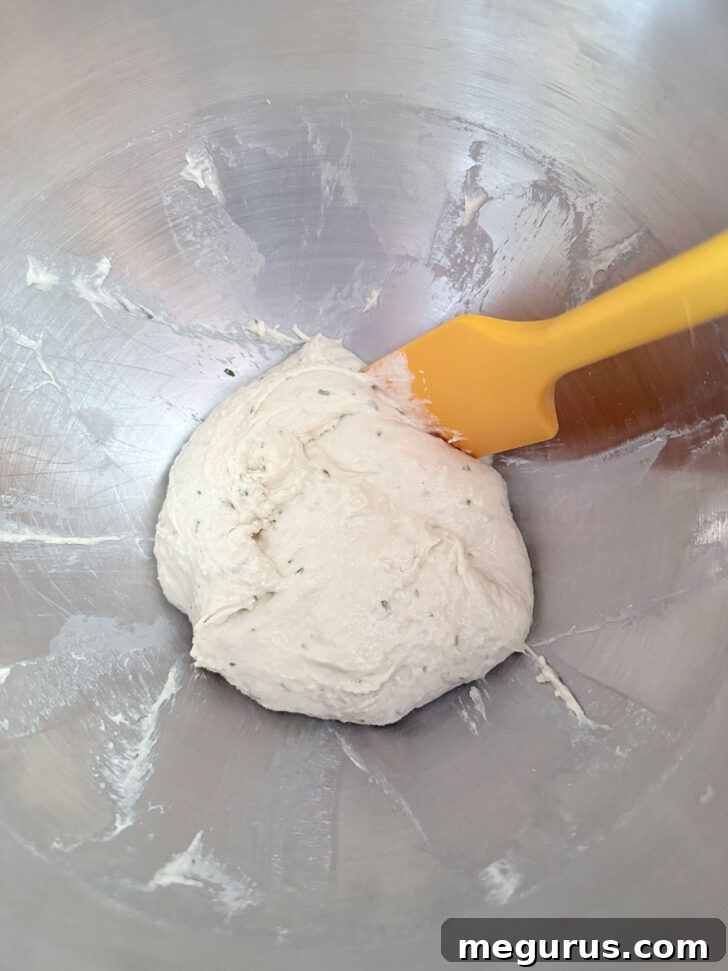 Sticky focaccia dough after mixing in a mixer bowl.