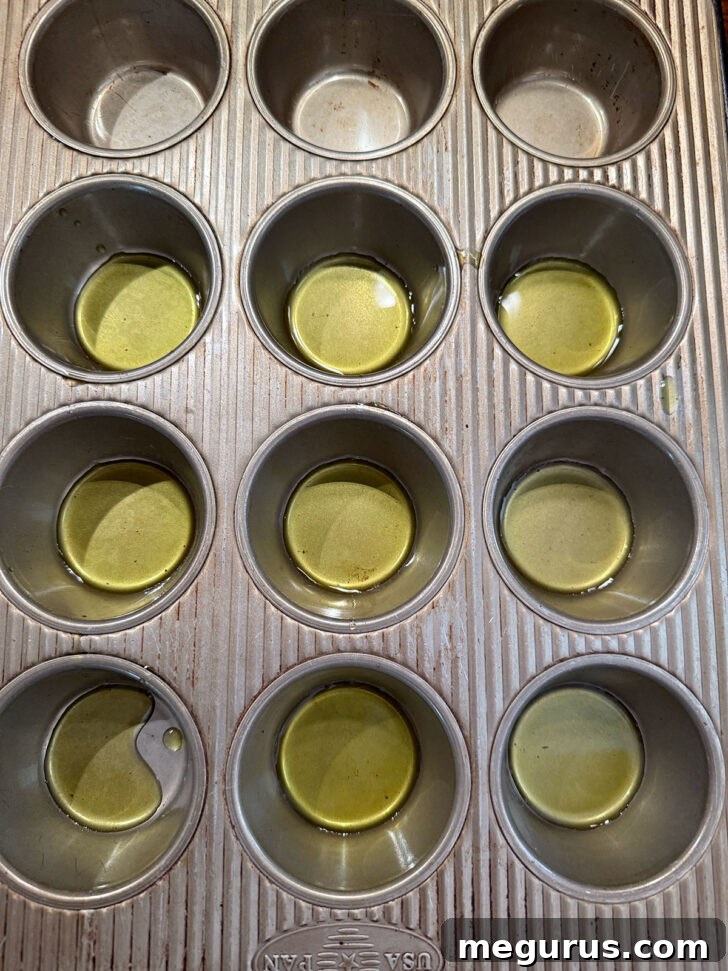 Olive oil added to the bottom of muffin cups.