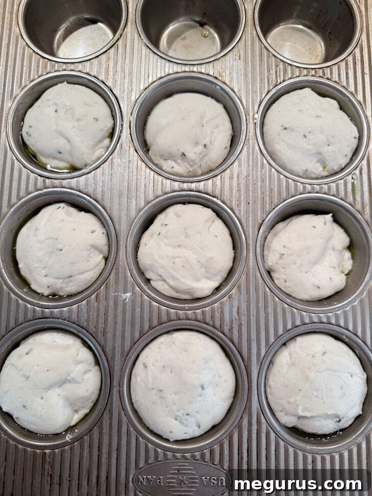 Focaccia muffins after rising, filling the muffin cups.