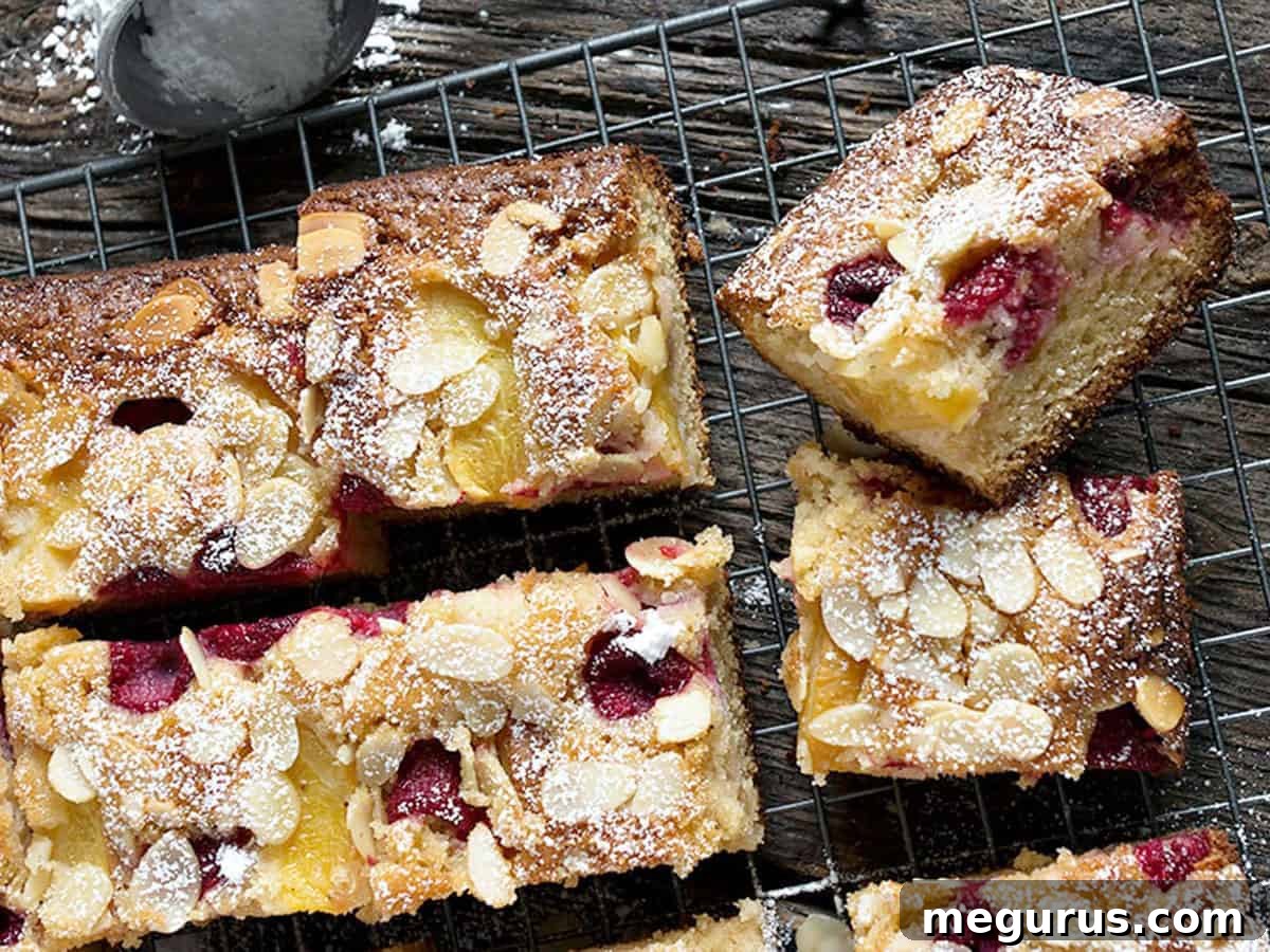 Sliced Peach Raspberry Almond Cake on a Cooling Rack