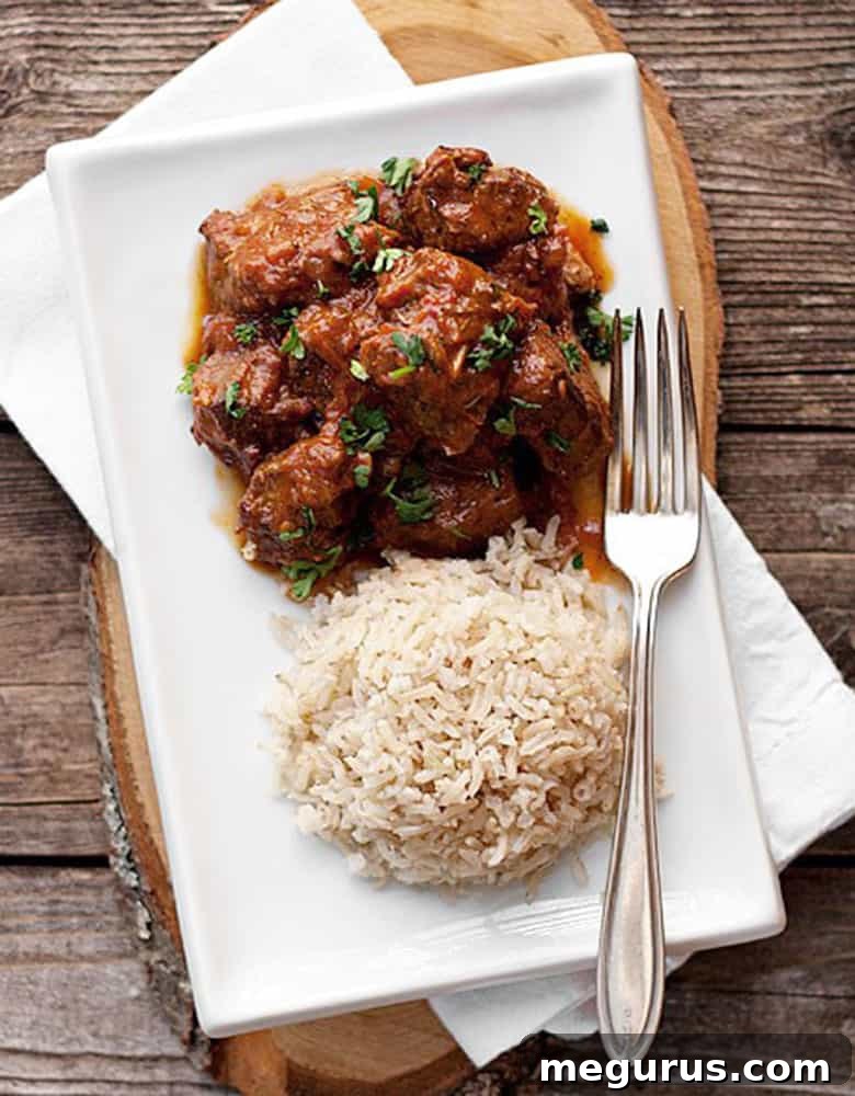 Close-up of tender beef curry served with rice, showcasing the rich sauce and spices.