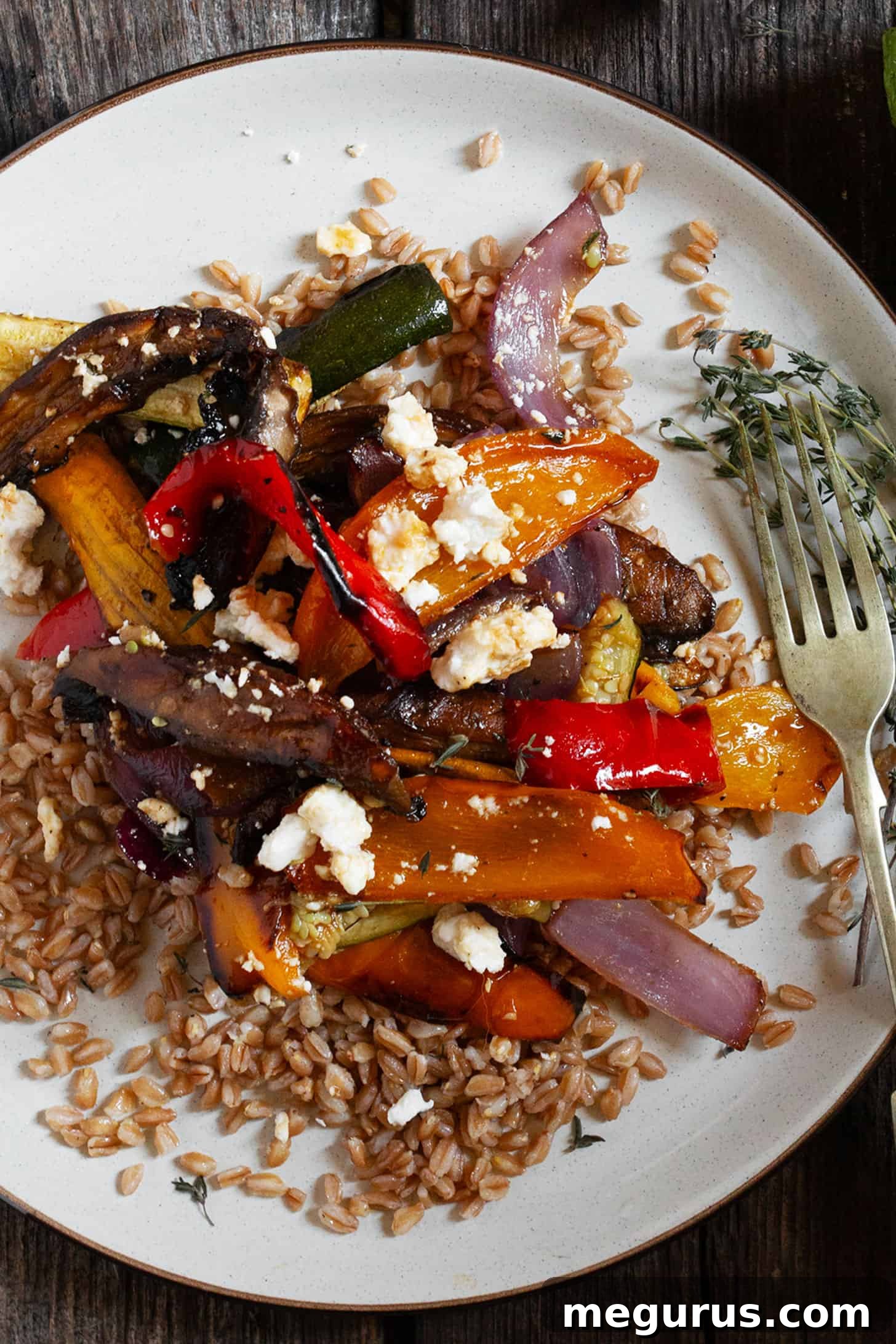 A close-up of roasted vegetable farro salad, highlighting the perfectly cooked farro and caramelized vegetables.