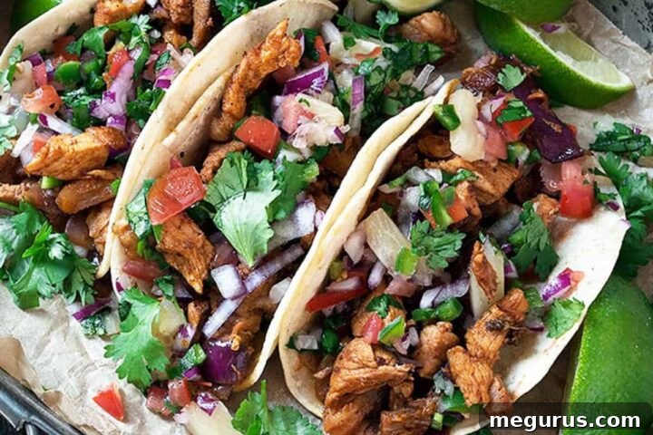 Quick and Easy Tacos Al Pastor served on a rustic platter with lime wedges.