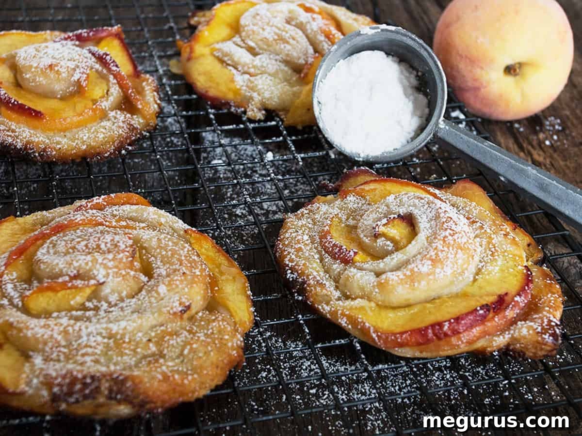 Rose-shaped peach puff pastries cooling on a rack