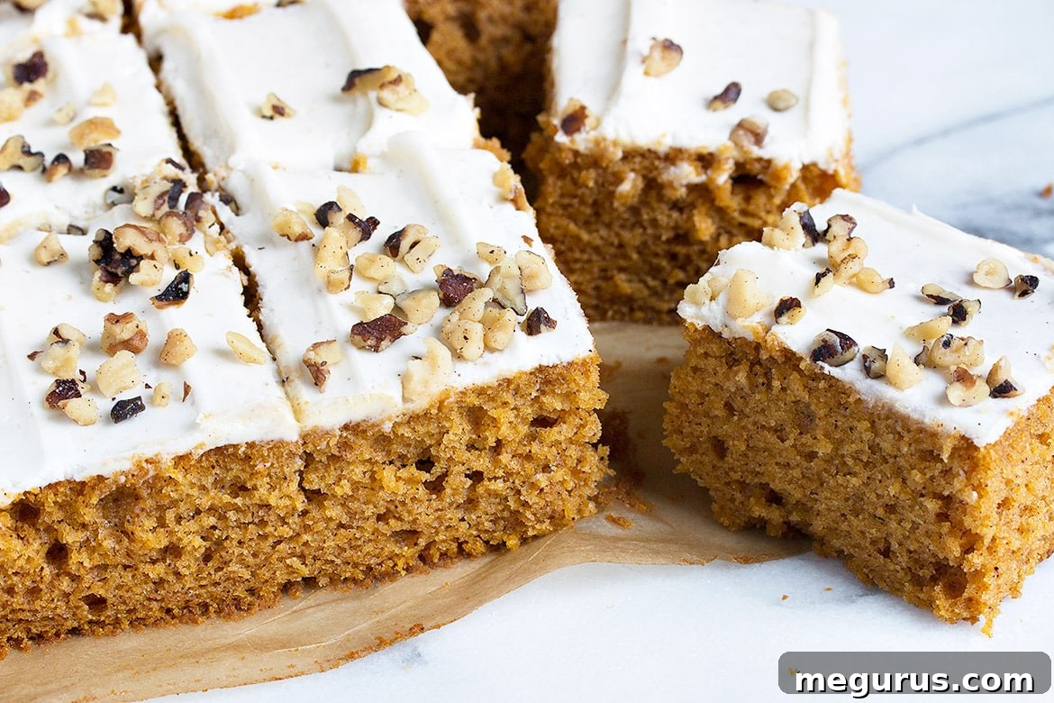 Deliciously sliced pumpkin sheet cake revealing moist texture and creamy frosting
