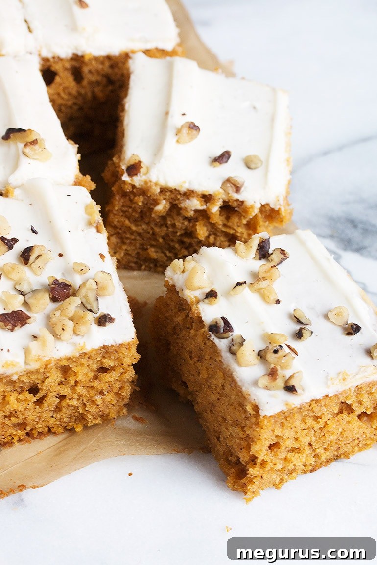 Top-down view of a Pumpkin Sheet Cake with Cream Cheese Frosting and walnut garnish