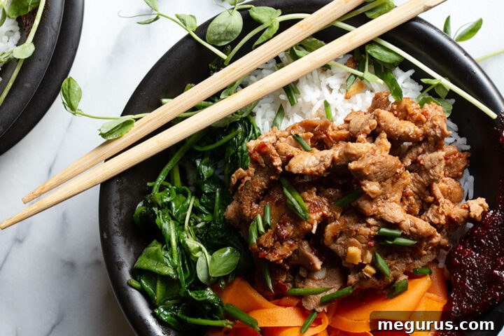 Spicy pork rice bowl served with chopsticks, ready to eat