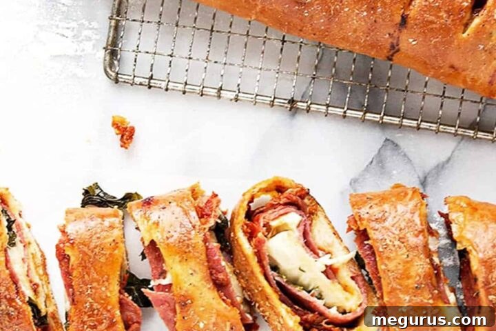 Classic stromboli sliced, revealing the golden crust and savory filling.