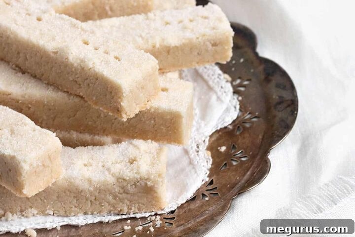 Scottish shortbread cookies on old sliver platter, showcasing their golden-brown edges and delicate appearance.