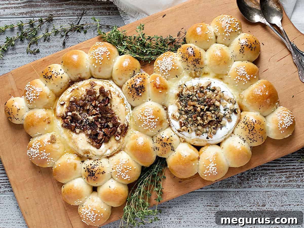 Golden brown bread bites with two perfectly baked rounds of Brie and Camembert, ready to be served on a rustic wooden cutting board, highlighting an ideal party appetizer.
