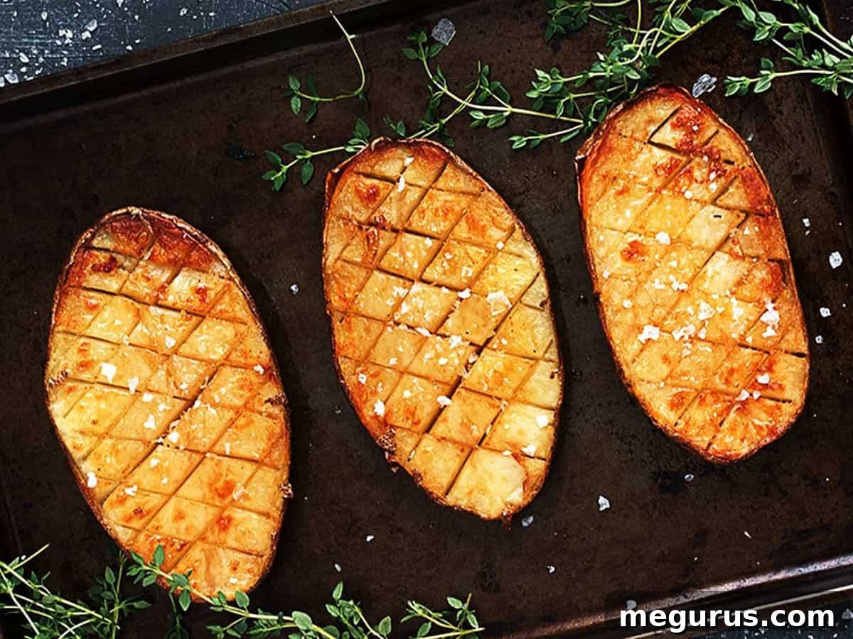 Golden brown crispy salt and malt vinegar roasted Russet potatoes on a baking sheet, ready to be served.