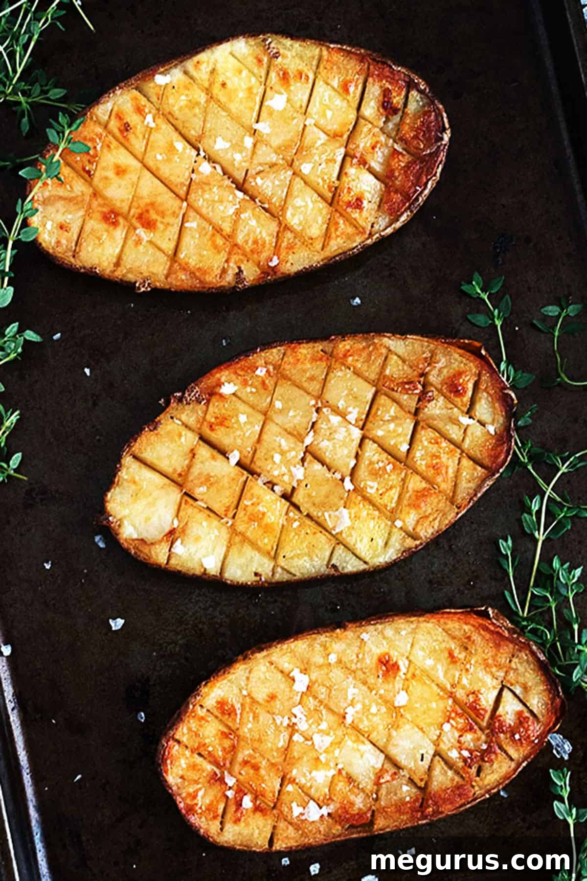 Close-up of salt and malt vinegar roasted Russet potatoes with a visible diamond scoring pattern, showcasing their crispy texture.