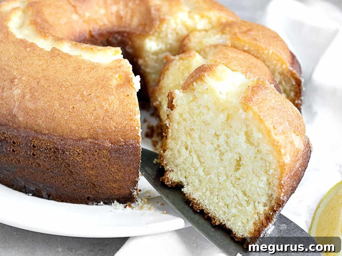Sliced lemon tube cake on a white plate, showcasing its beautiful texture