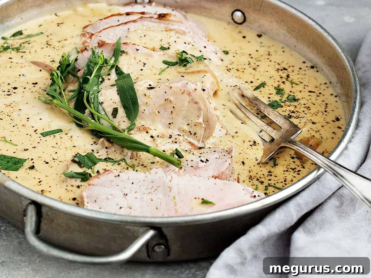 Pork loin tarragon sliced in pan with sauce, garnished with fresh herbs
