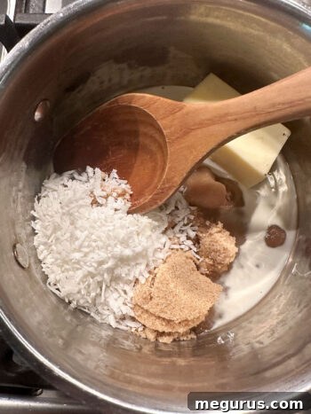 Ingredients for the coconut topping, including brown sugar, butter, and cream, simmering in a saucepan
