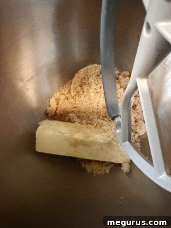 Softened butter and brown sugar are creamed together in a stand mixer