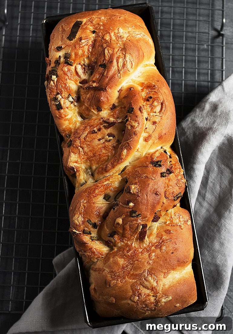 Whole loaf of golden-brown potato bread with twisted top