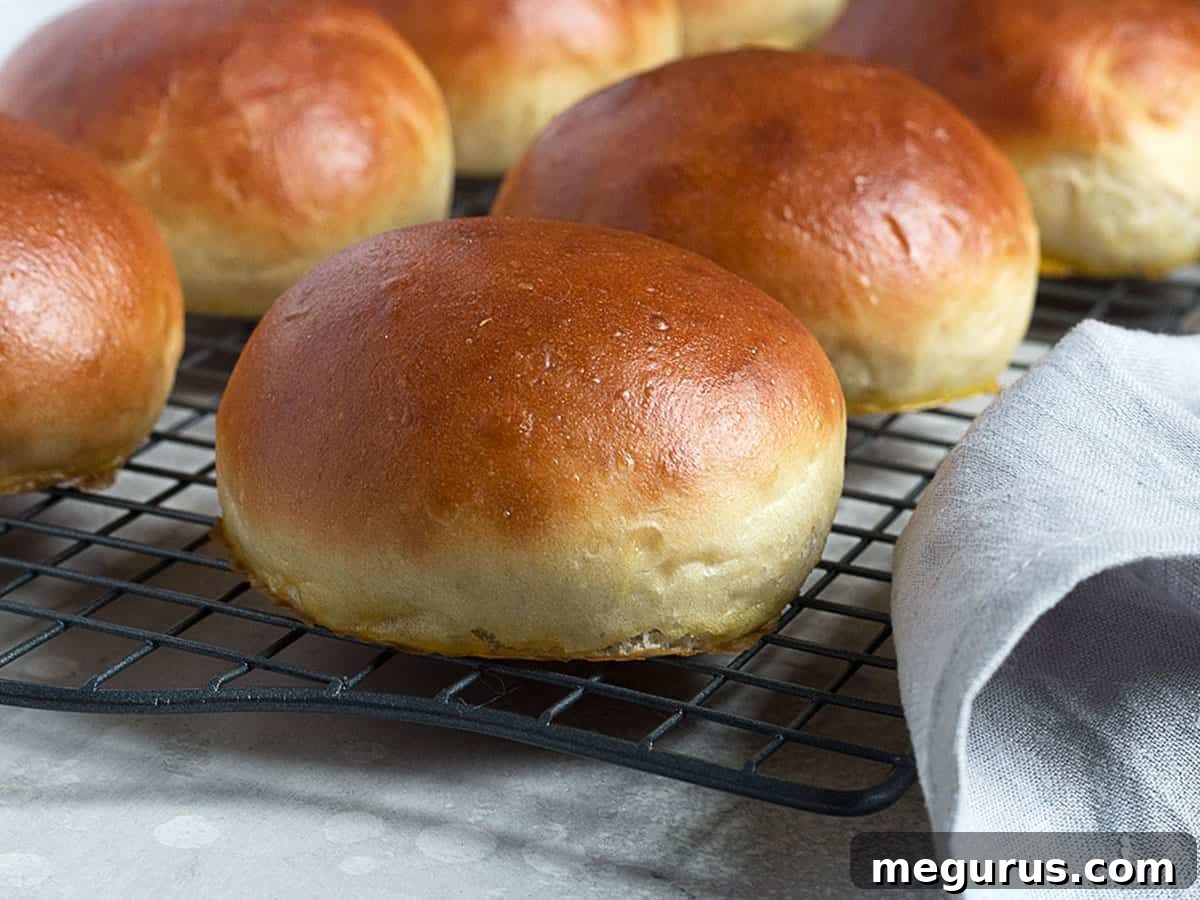 Freshly baked homemade hamburger buns cooling on a wire rack