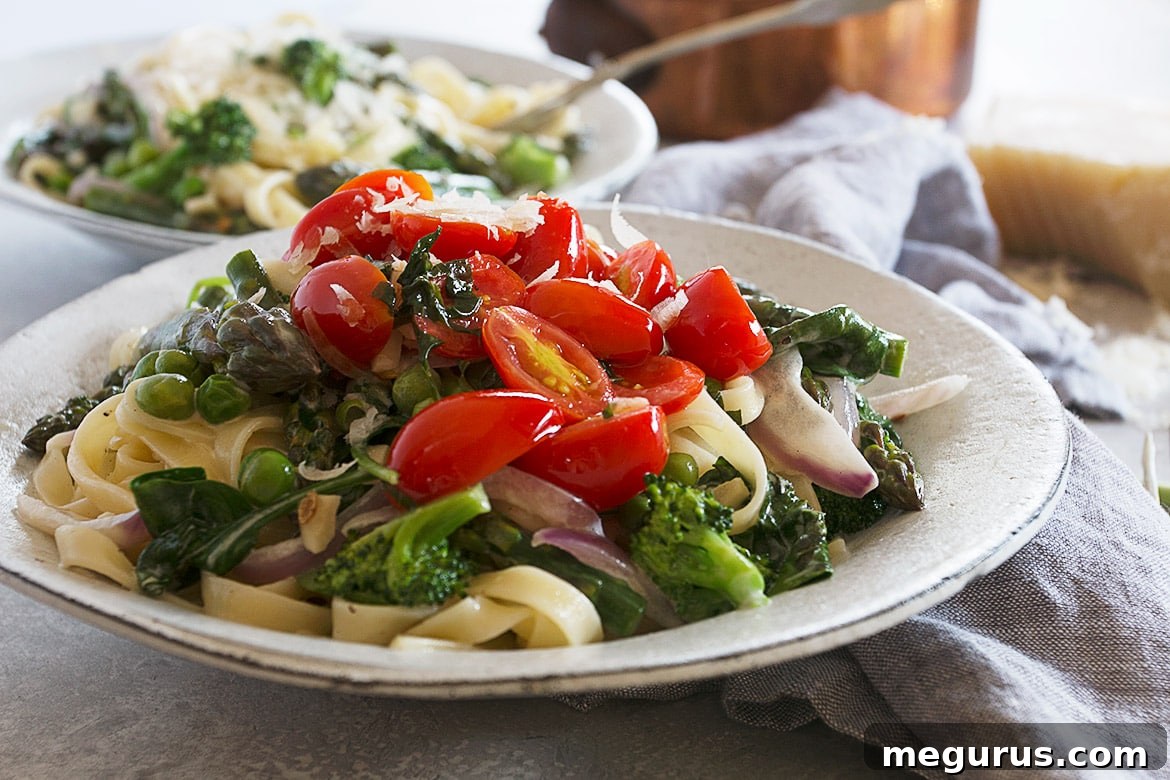 Classic Pasta Primavera served in a bowl, garnished with fresh herbs and a drizzle of olive oil.