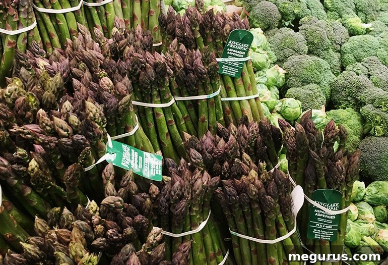 Fresh asparagus spears bundled together, likely purchased from a market, ready for cooking.
