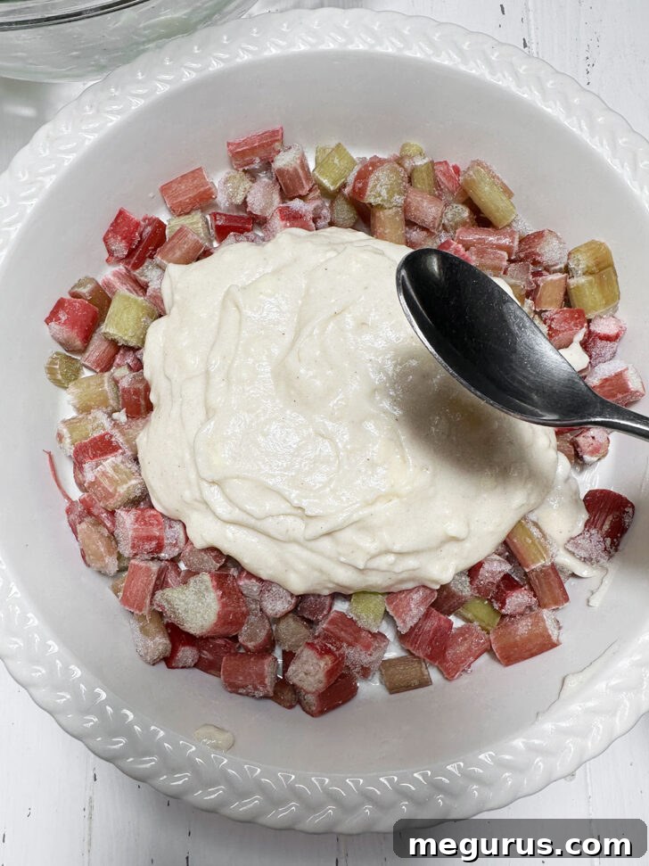 Spreading the batter overtop of the rhubarb.