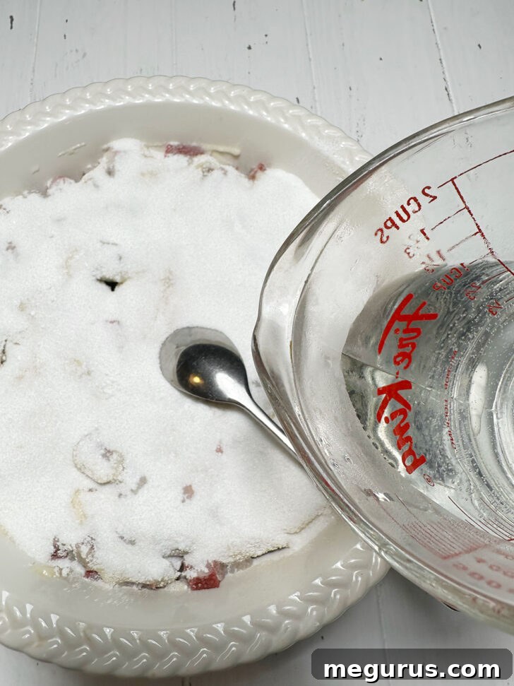 Pouring boiling water over batter and sugar.
