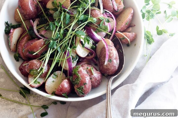 Mini red potato salad in a white bowl, ready to be served