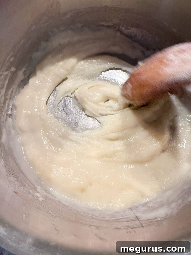 Smooth, thick mixture of butter, flour, and beer in the saucepan after thorough stirring.