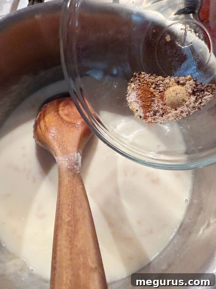 Various spices and Worcestershire sauce added to the thickening mixture in the saucepan.