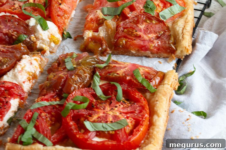 tomato ricotta tart sliced on parchment paper