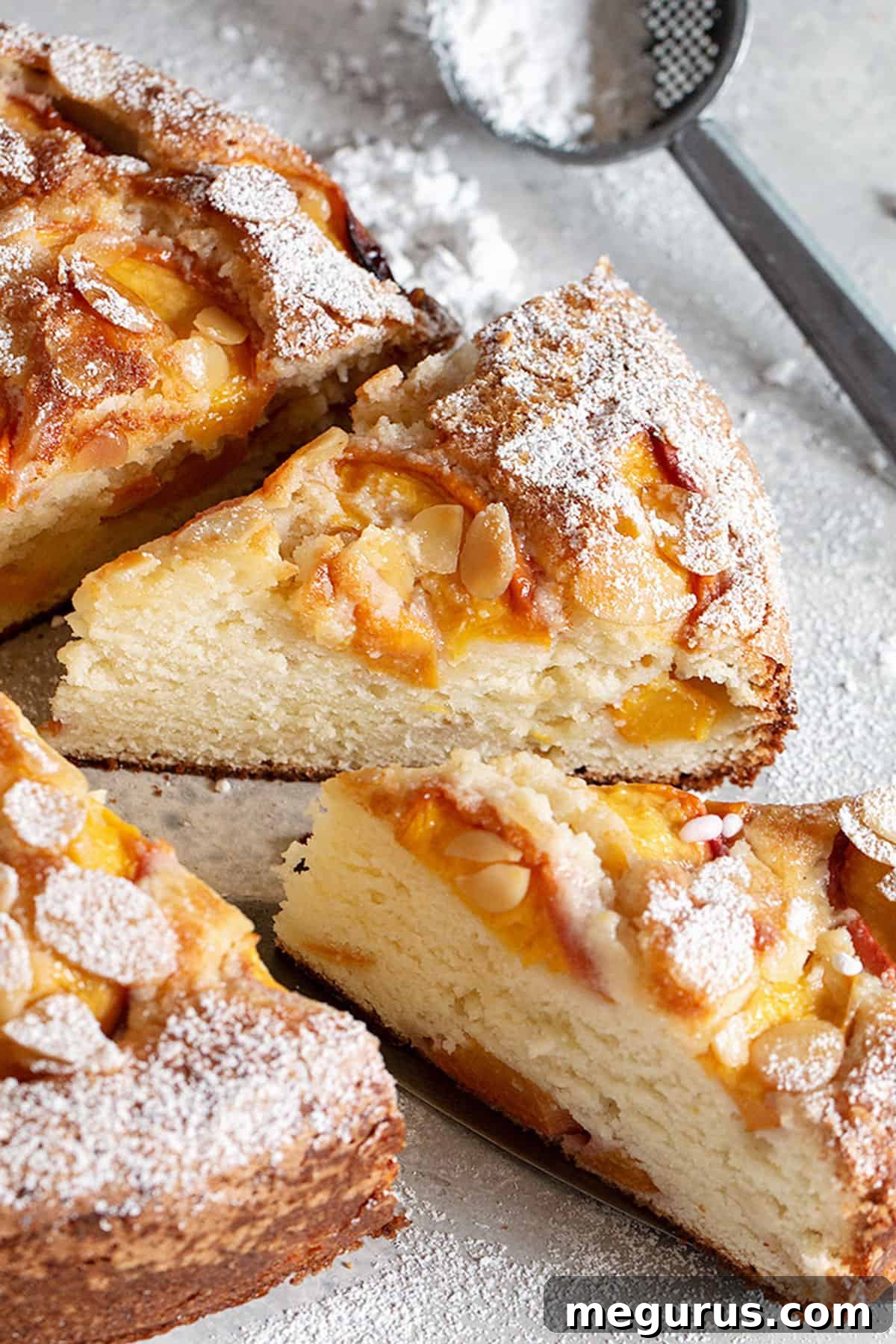 Close-up of a generously sliced peach ricotta cake revealing its moist interior and perfect fruit distribution, ready to be enjoyed