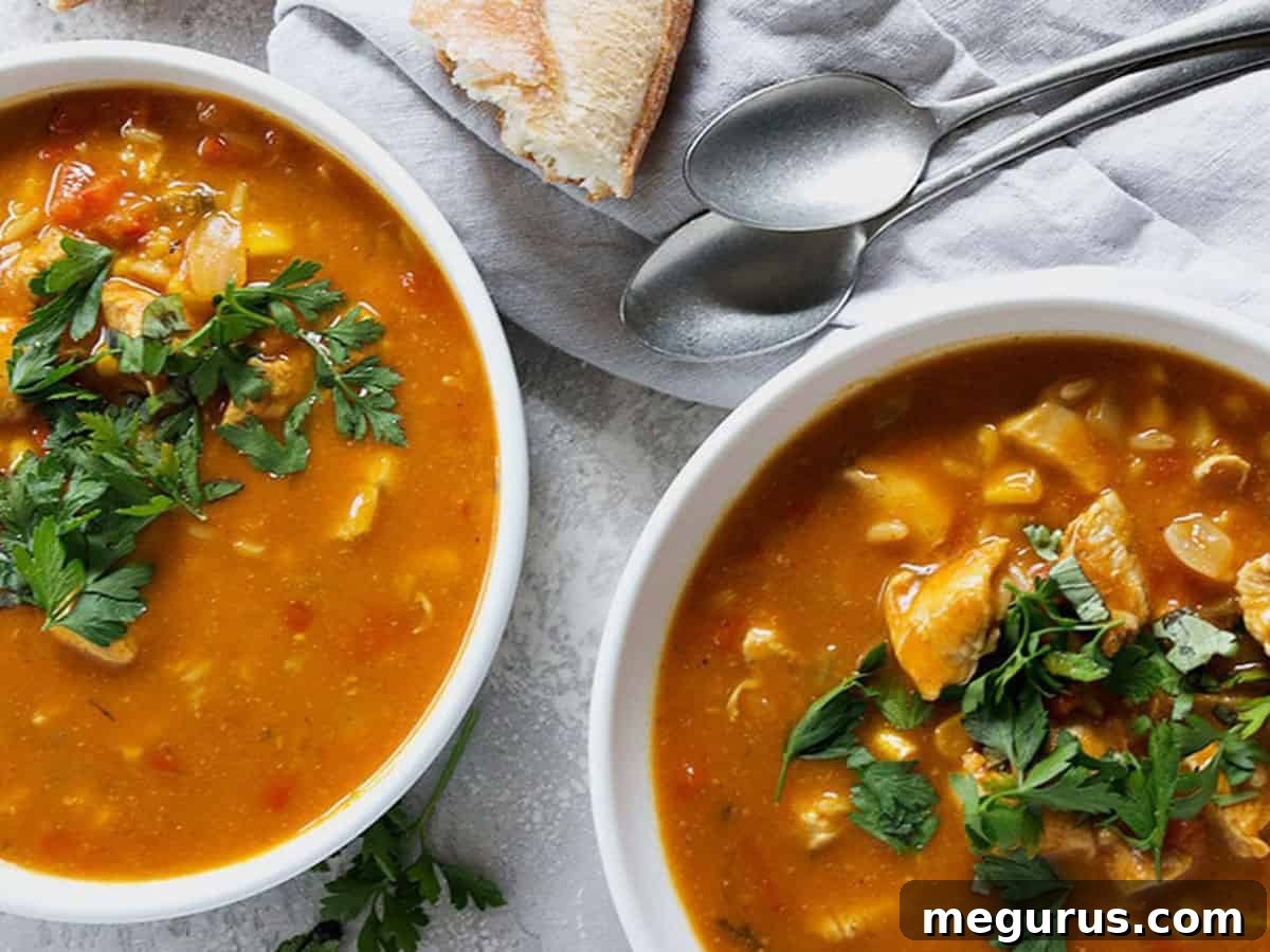 Rich pumpkin chicken soup in elegant white bowls, ready to be served