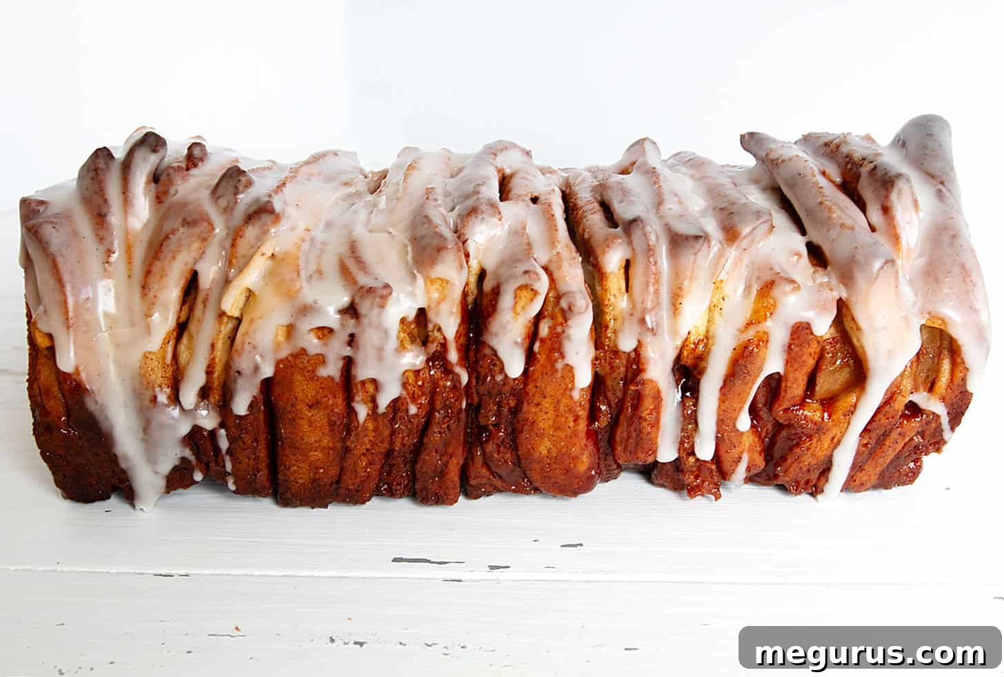 Close-up of a rustic pull-apart apple fritter bread, showcasing its golden crust and delicious texture.