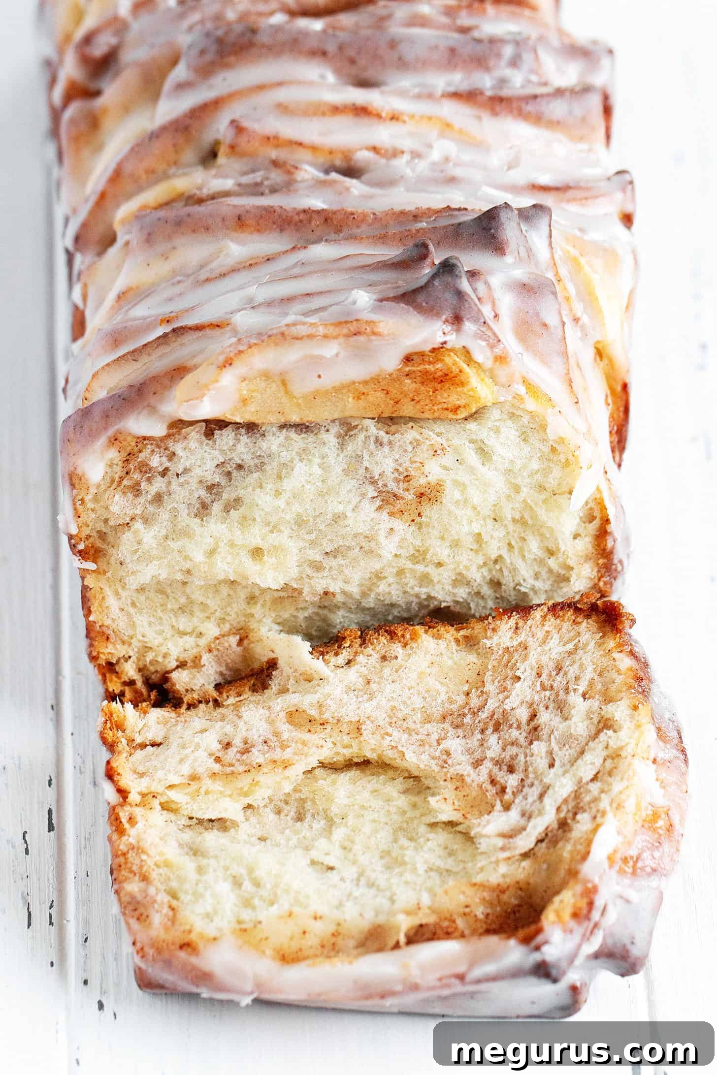 Sections of pull-apart apple fritter bread, revealing the cinnamon-sugar swirl and roasted apple pieces inside.
