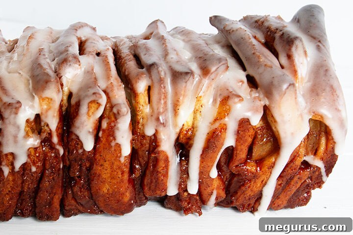 Profile view of a baked Pull Apart Apple Fritter Bread with glaze.