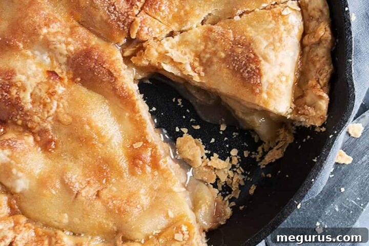 brown sugar peach pie sliced in cast iron skillet