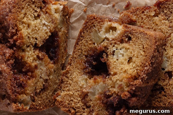 apple cinnamon loaf sliced on parchment paper