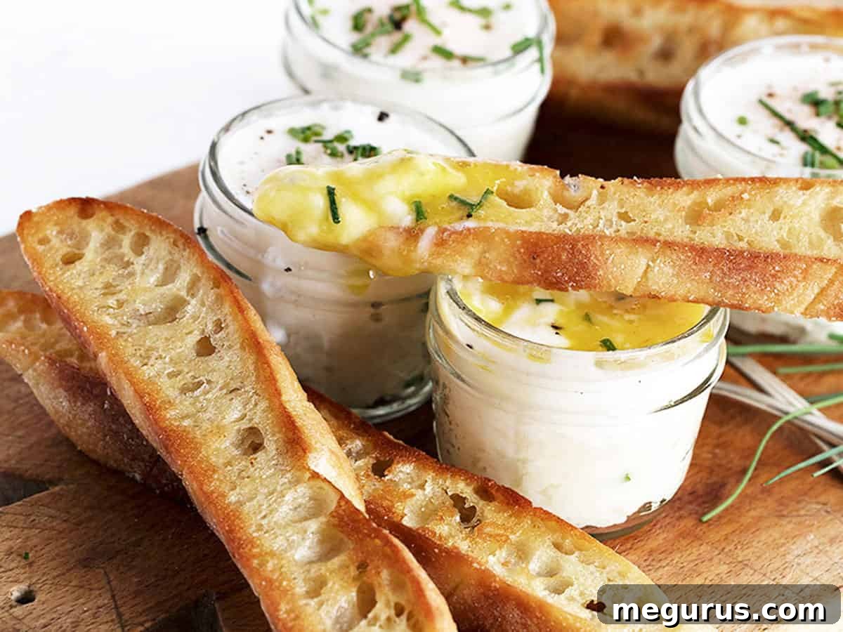 Delicate coddled eggs served in small jars with creamy mashed potatoes, ready for a comforting meal.