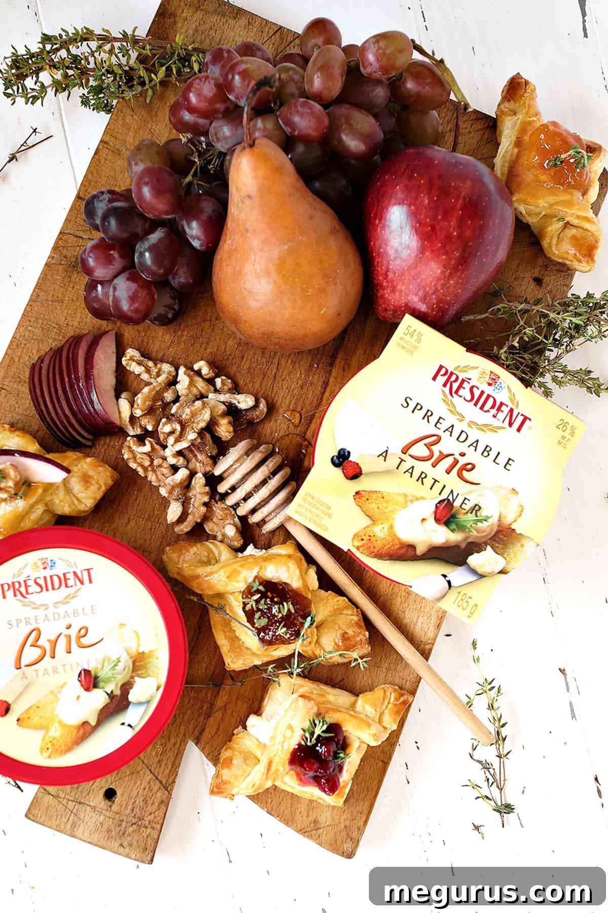 spreadable brie puff pastries with jam on cutting board