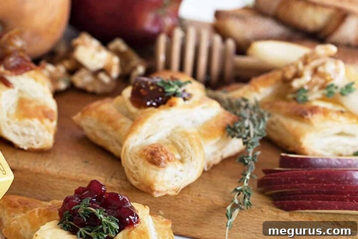 spreadable brie puff pastries with jam on cutting board