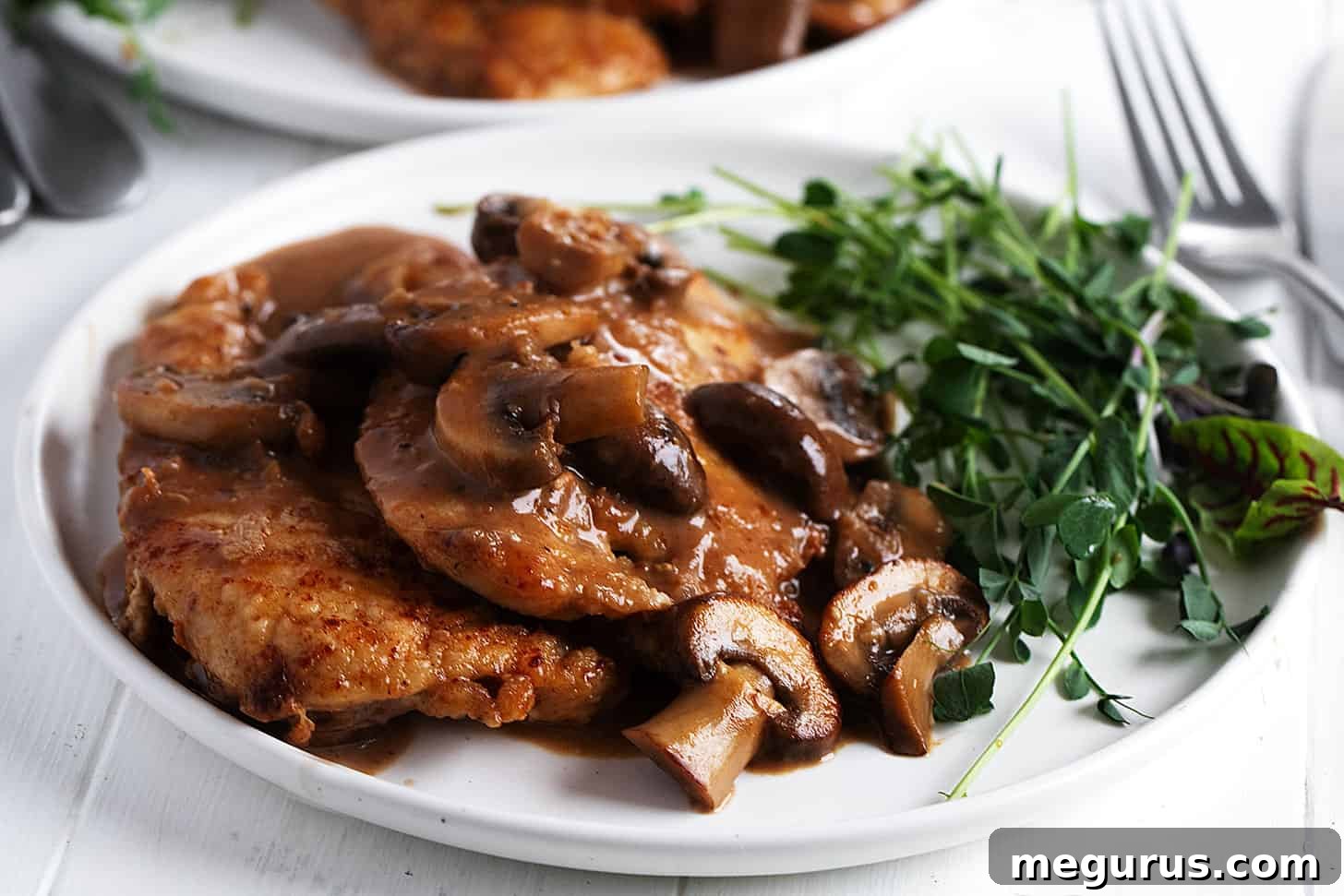 classic chicken marsala on plate with greens
