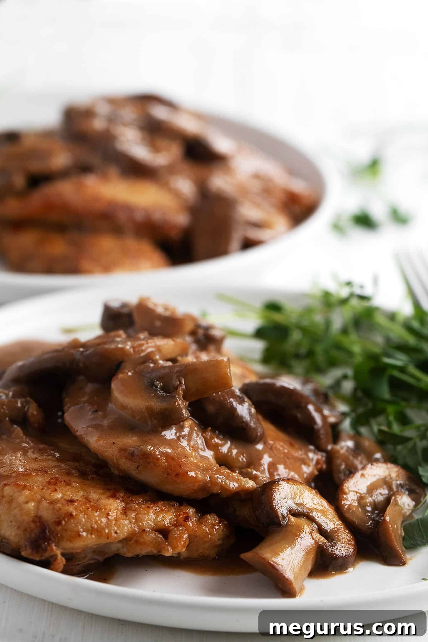 classic chicken marsala on plate with greens
