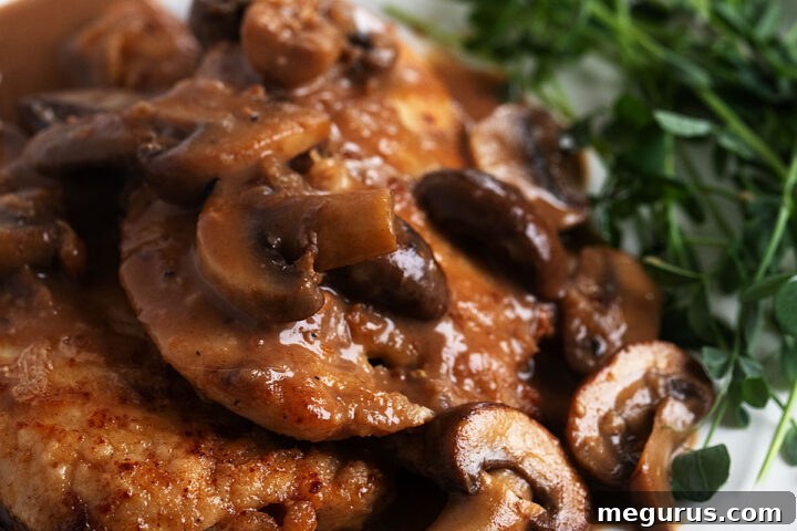 classic chicken marsala on plate with greens