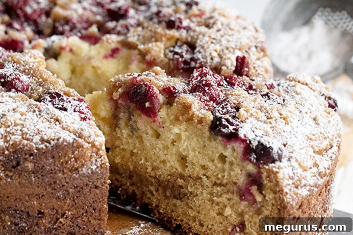 cranberry streusel cake sliced on serving board