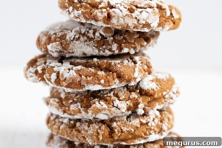 Stacked ginger crackle cookies with a strong crackle pattern, ready to eat.