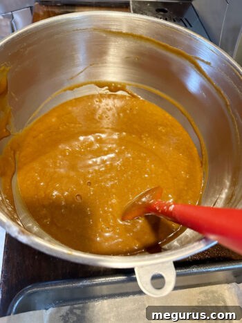 The fully prepared, smooth gingerbread cake batter resting in the mixing bowl, ready for transfer to the baking pan.